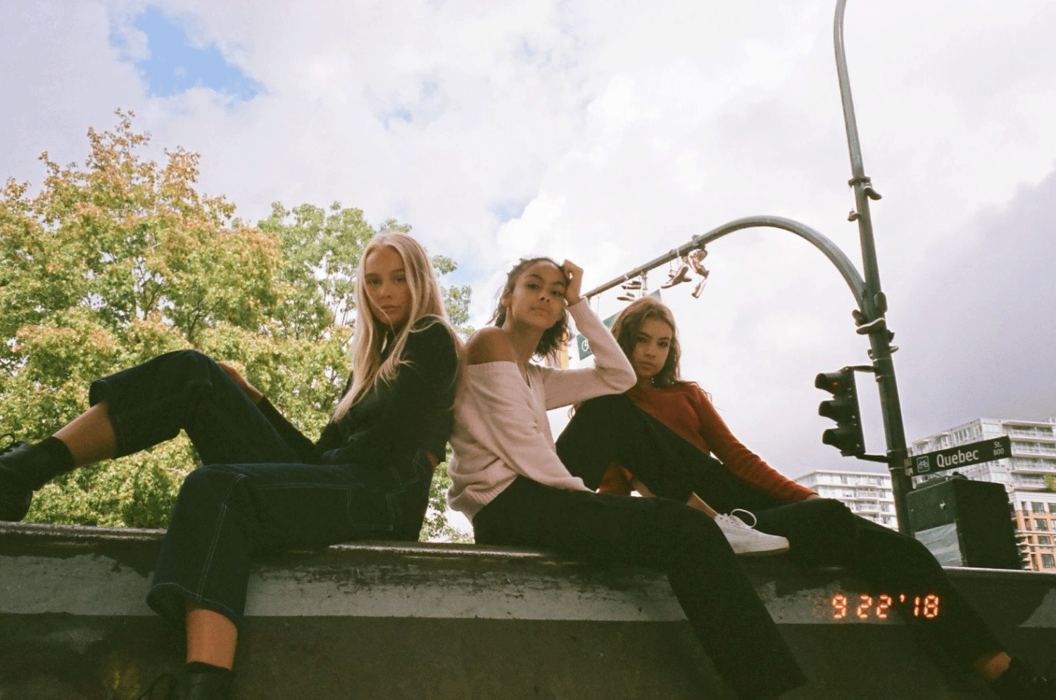 Three girls sitting on the edge of a skateboard ramp. Shot on 35mm film.
