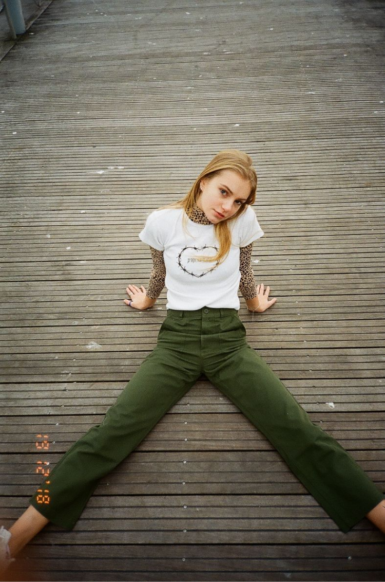  Aubrey sitting on the boardwalk in Toronto. Shot on 35mm film.