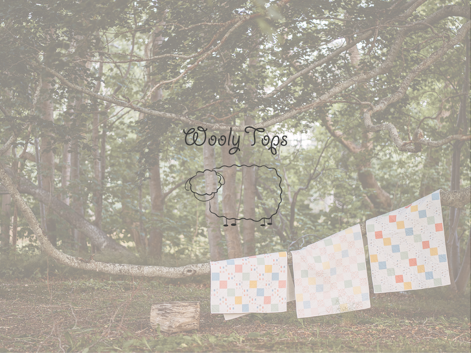 The Wooly Tops logo overlaid on an image of three quilts hanging in a large tree.